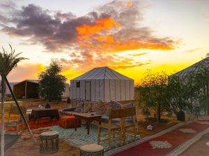 Desert camp in Erg Chebbi at sunset with Berber carpets