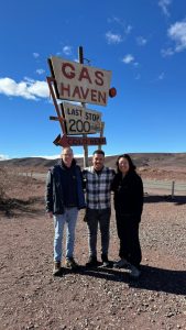 Roadside sign on the desert road south, with travellers on the way to Merzouga