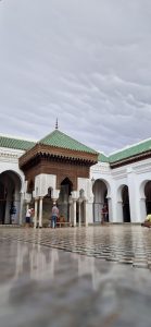 Carved gate with a green-tiled roof in Fes