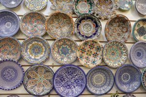 Wall of hand-painted Moroccan ceramic plates in a medina workshop
