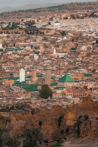 Rooftops and green-tiled minarets of the Fes medina
