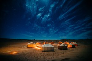 Desert camp lit up under the stars in Erg Chebbi