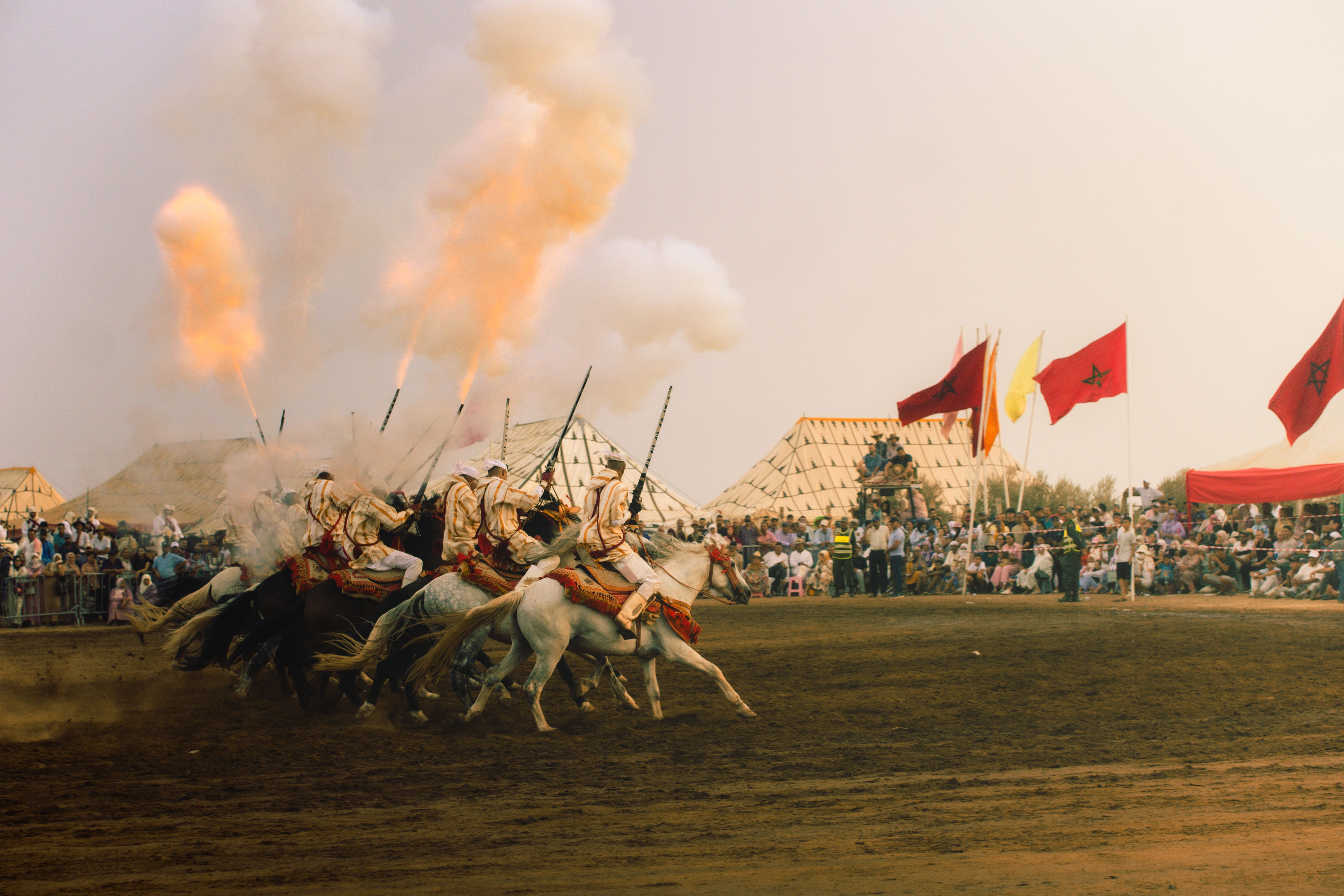 fantasia show Marrakech riders firing at full gallop"